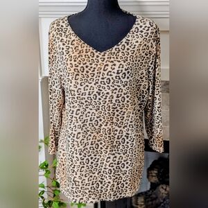 Cream background with black and brown animal print V-neck 3/4 Sleeve Top.